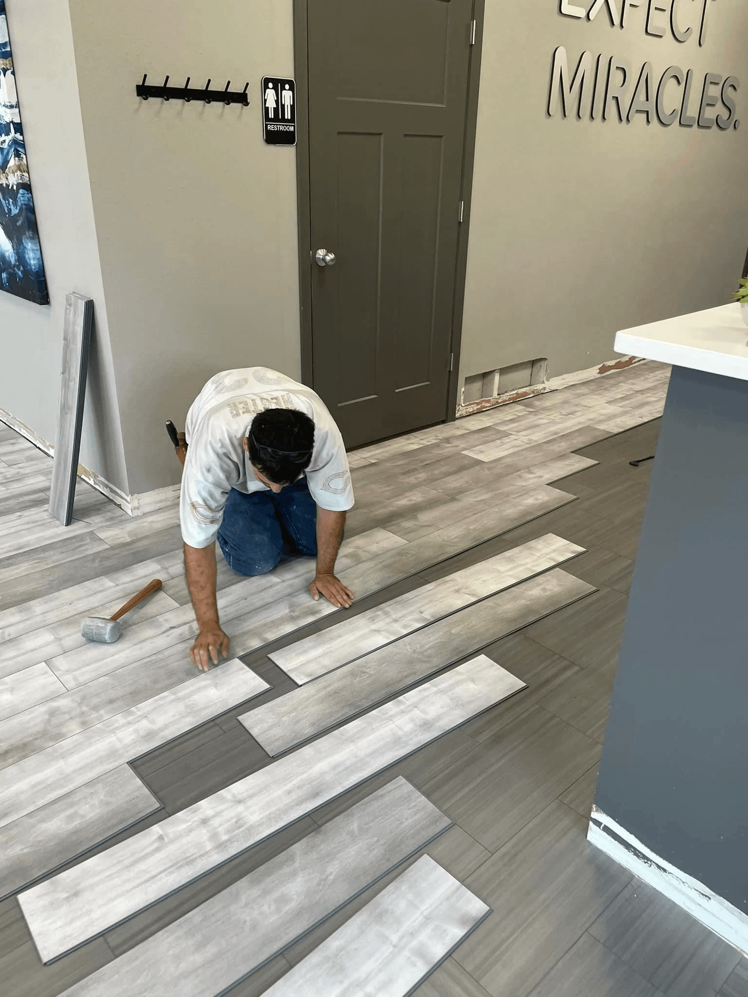 man putting in flooring